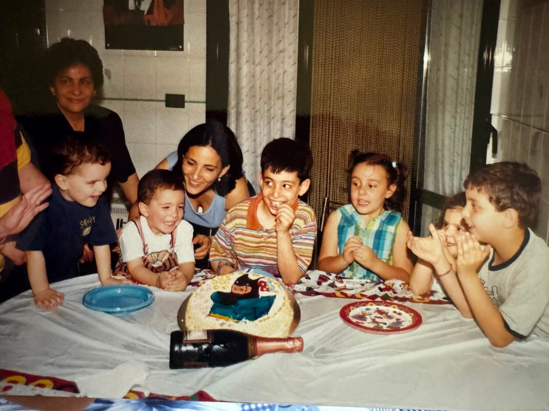 The founders as kids around a birthday cake with their family